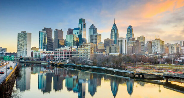 Philadelphia Pennsylvania city skyline reflecting on river at sunset