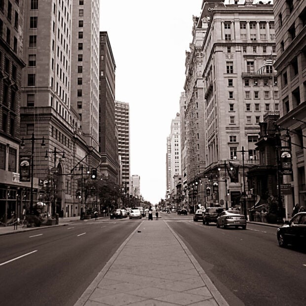 Historic Philadelphia Pennsylvania street with tall buildings and cars in black and white