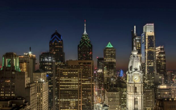 Philadelphia city skyline at night with lit buildings and Pennsylvania landmarks