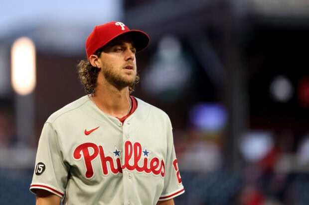 A Philadelphia Phillies player wearing a gray uniform with a red cap on the baseball field