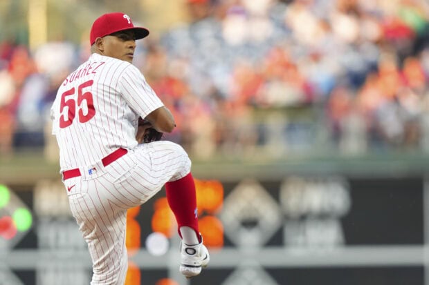 Baseball player Suarez pitching for Philadelphia Phillies on the field in a crowded stadium