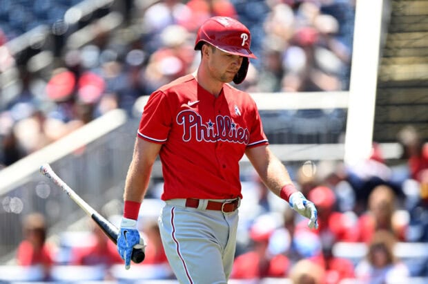 A Philadelphia Phillies player in red uniform preparing to bat during a baseball game
