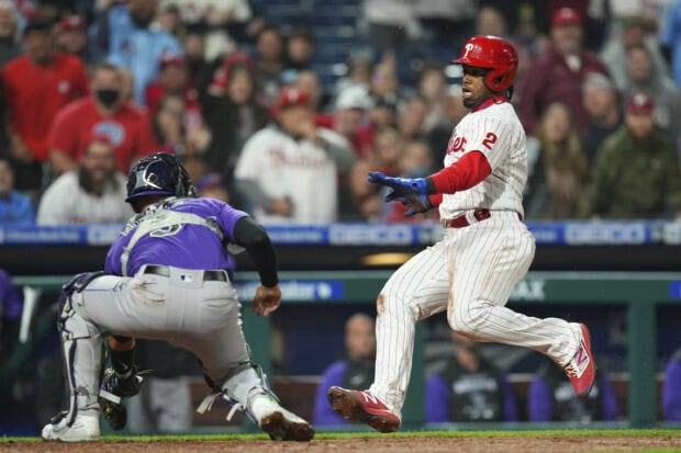 A Philadelphia Phillies player sliding into home base during a baseball game