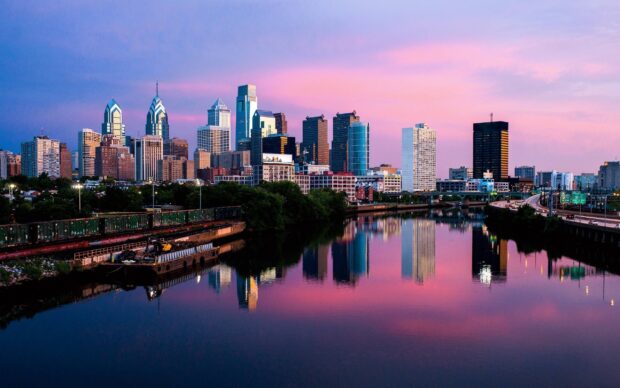 Philly skyline with river reflection during a colorful sunset in a vibrant cityscape