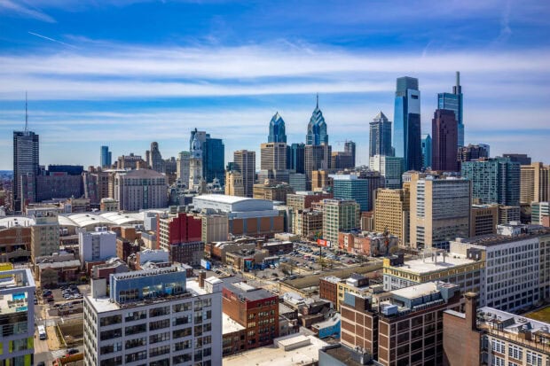A clear view of Philly skyline with modern skyscrapers and historical buildings under blue sky