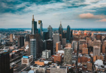 Philly skyline with tall modern buildings under a partly cloudy sky