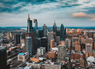 Philly skyline with tall modern buildings under a partly cloudy sky