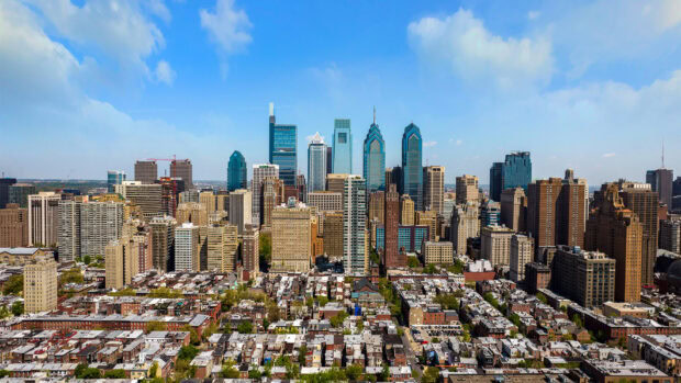 A clear view of the Philly skyline with modern buildings and residential areas under a blue sky
