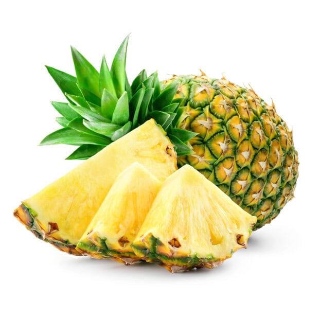 Fresh pineapple fruit with green leaves and sliced pieces on a white background