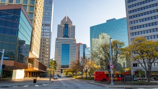 Modern skyscraper and cityscape in Pittsburgh with Highmark building and trees lining the street