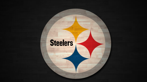 The Steelers emblem displayed on a wooden floor surface in Pittsburgh style