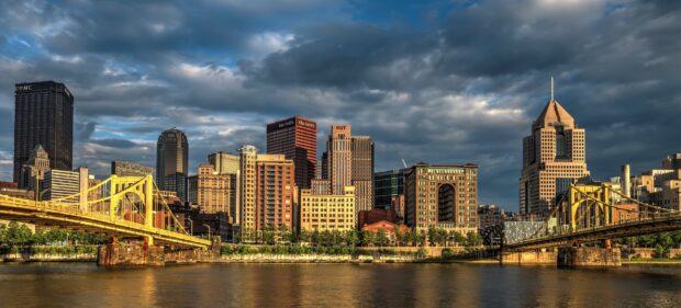 The Pittsburgh cityscape with bridges and skyscrapers under a cloudy sky