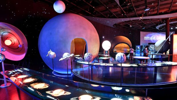 Planetarium exhibit showing various planets and celestial models in a detailed planetarium setting