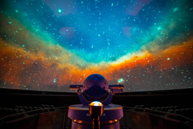 A planetarium featuring vibrant nebulae and stars in the night sky planetarium