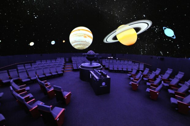 A planetarium showing a detailed model of planets in the solar system