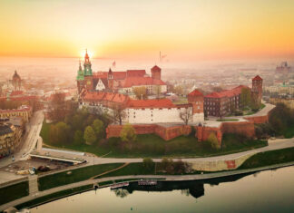 Historic architecture of Poland captured at sunrise with a river in the foreground