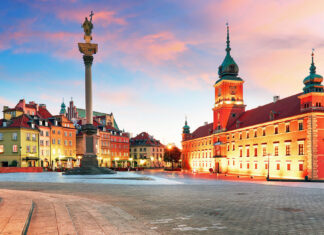 The old town square with royal castle and sigismund column in poland at sunset