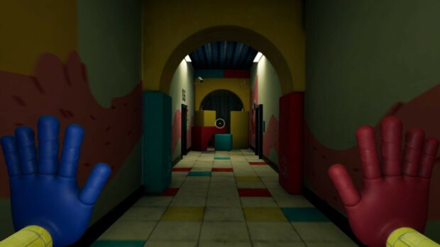 A first person view in Poppy Playtime with colorful mechanical hands and a hallway with blocks