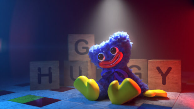 Huggy is sitting with colorful wooden blocks in a dark room