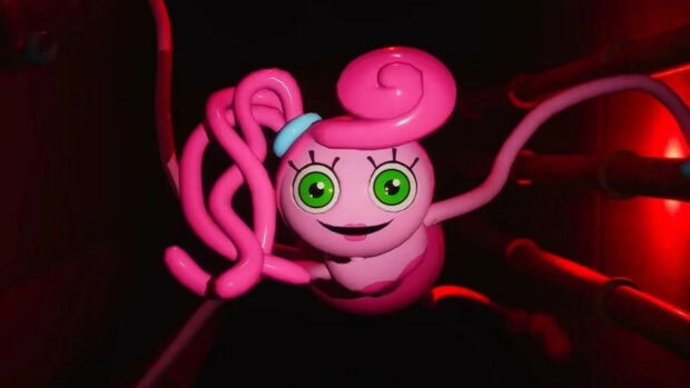 A cute character from Poppy with bright green eyes and pink curly hair in a dark setting