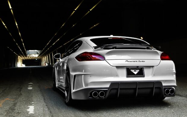 White Porsche Panamera Turbo car parked in a dark tunnel with glowing ceiling lights