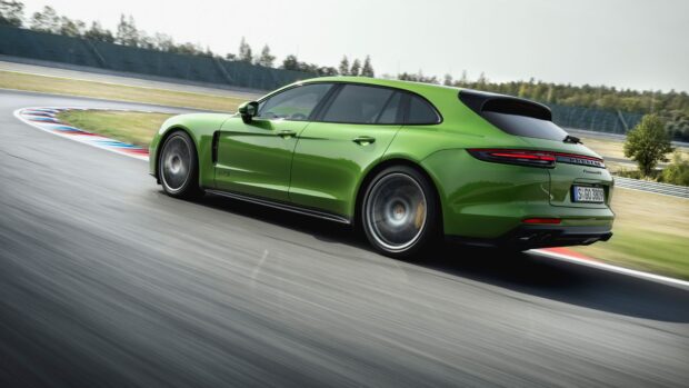 Green Porsche Panamera driving fast on racing track