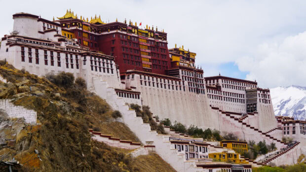 The Potala Palace is a historic building situated on a hillside in Tibet