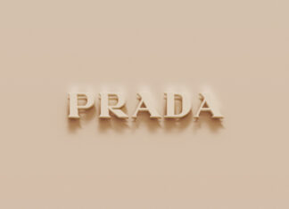 Beige textured surface with raised Prada logo casting soft shadows