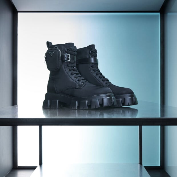 Black Prada boots with chunky soles and side pouch on a metal shelf