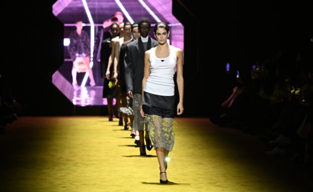 Female model wears Prada outfit walking in fashion show runway