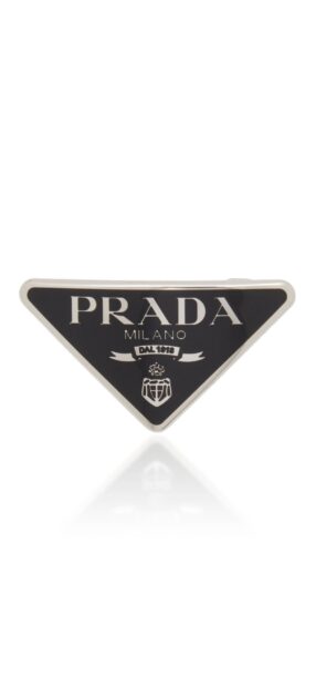 Close up of Prada logo in black and silver on a triangular badge