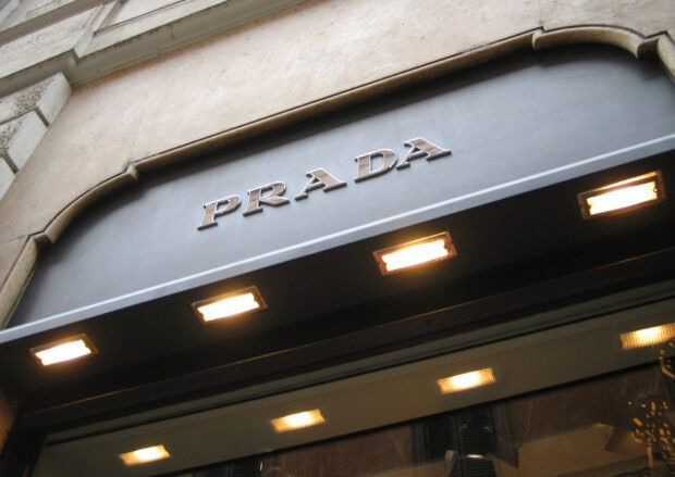 The Prada store sign is displayed above the entrance with illuminated lights