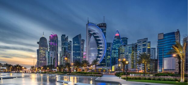 Modern Qatar skyline with illuminated buildings at dusk in the city center