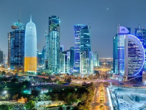 Modern skyline in Qatar showcasing illuminated skyscrapers and urban landscape at night