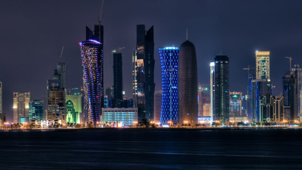 Night cityscape with illuminated Qatar skyline and modern skyscrapers