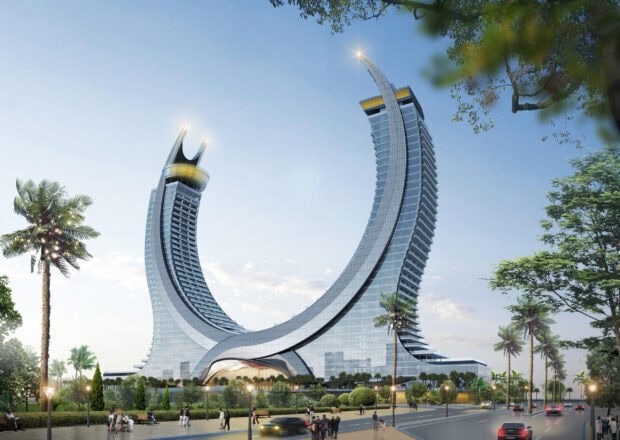 Modern Qatar architecture with unique curved towers and surrounding palm trees in a clear sky