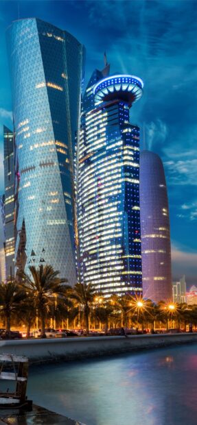 Modern architecture in Qatar with illuminated skyscrapers at night