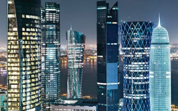 Modern Qatar cityscape with illuminated skyscrapers at night showing Qatar architecture