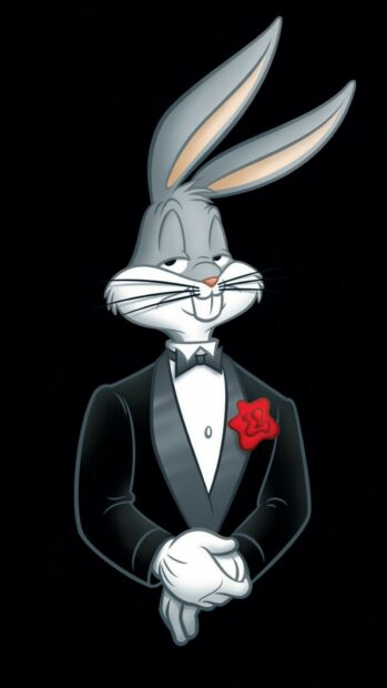 A confident rabbit wearing a tuxedo with a red flower on the lapel