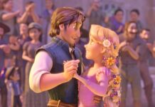 Rapunzel and Flynn Ryder sharing a dance surrounded by people in an animated scene