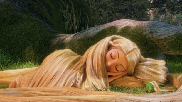 Rapunzel lying asleep outdoors with her long hair spread around her on the grass