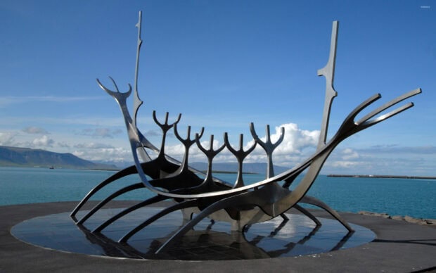 The Sun Voyager sculpture in Reykjavik against a clear blue sky and sea view