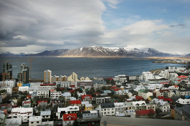 Colorful Reykjavik cityscape with mountains and ocean in the background