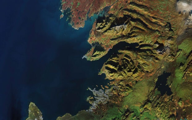 A detailed satellite view of Reykjavik showcasing the rugged coastline and surrounding terrain