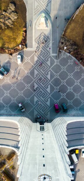 Aerial view of Reykjavik square with statue and geometric patterns on pavement