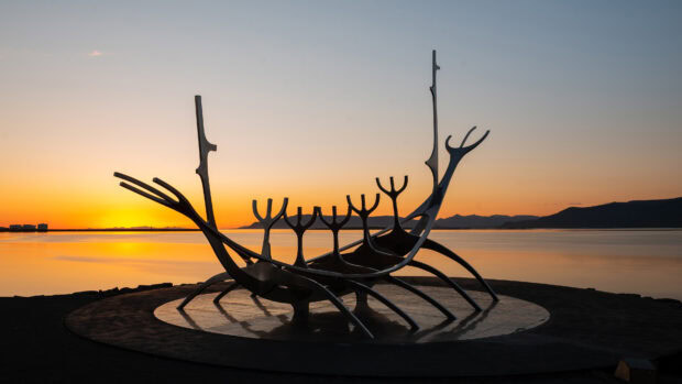 The Sun Voyager sculpture stands by the coast during sunset in Reykjavik