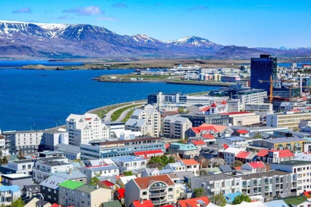Colorful Reykjavik cityscape with mountains and ocean in bright sunlight