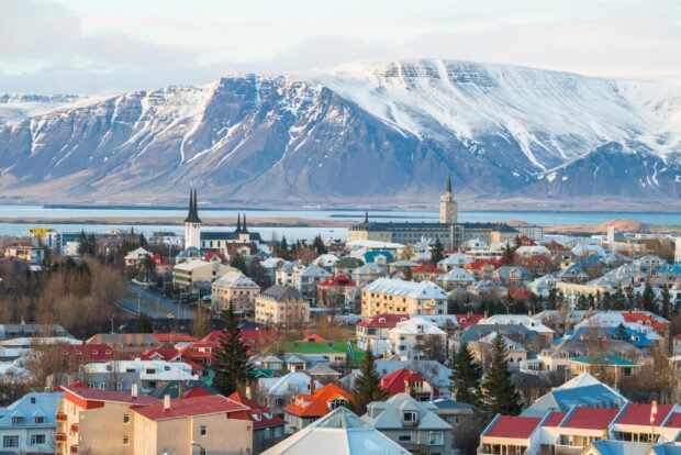 Colorful Reykjavik cityscape with snowy mountains in the background during winter