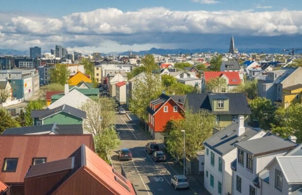 Colorful rooftops and cityscape of Reykjavik with clear skies and distant mountains