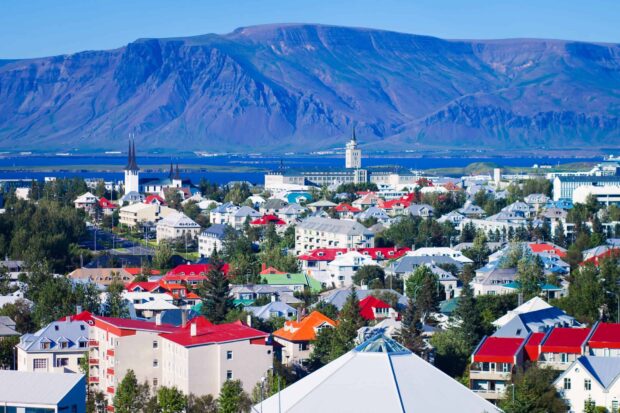 Colorful rooftops of Reykjavik with mountains in the background showing scenic Icelandic cityscape